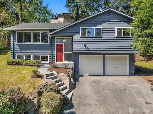 1136 N 146th Pl, Shoreline, WA 98133 - bi-level home with asphalt driveway, a garage, a chimney, and a front yard