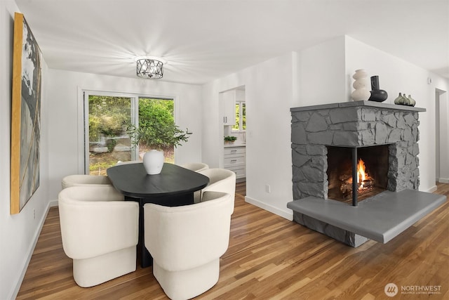 1136 N 146th Pl, Shoreline, WA 98133 - dining room featuring wood finished floors, a fireplace, and baseboards