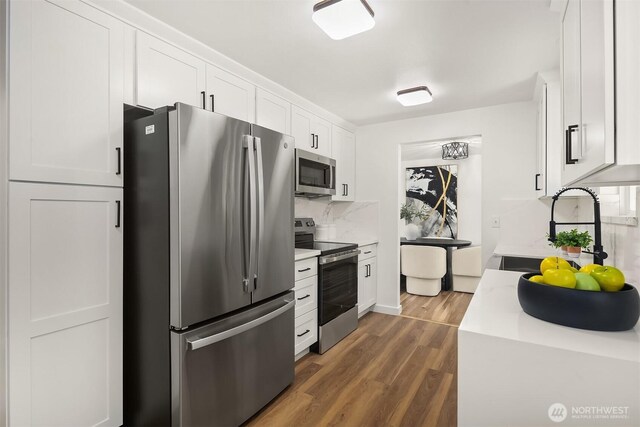 1136 N 146th Pl, Shoreline, WA 98133 - kitchen featuring stainless steel appliances, a sink, dark wood-type flooring, light countertops, and white cabinets