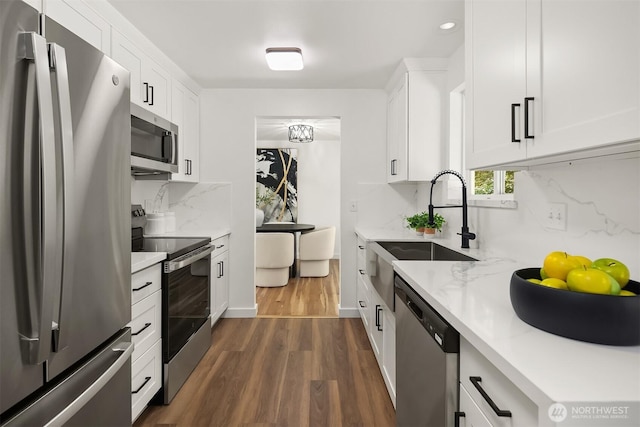 1136 N 146th Pl, Shoreline, WA 98133 - kitchen featuring appliances with stainless steel finishes, a sink, dark wood-style floors, backsplash, and white cabinets
