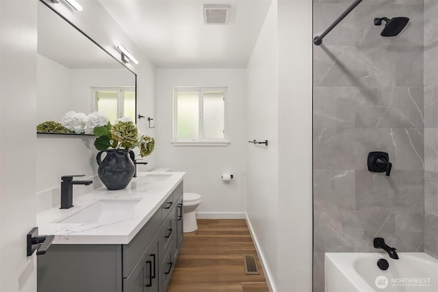 1136 N 146th Pl, Shoreline, WA 98133 - bathroom with double vanity, baseboards, wood finished floors, toilet, and  shower combination