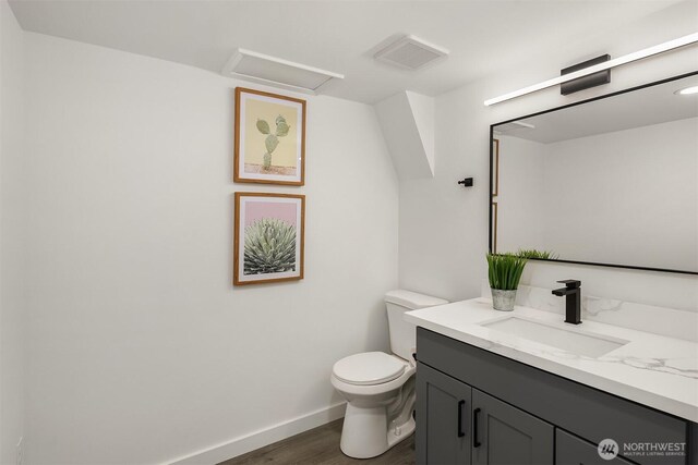 1136 N 146th Pl, Shoreline, WA 98133 - bathroom featuring vanity, wood finished floors, toilet, and baseboards