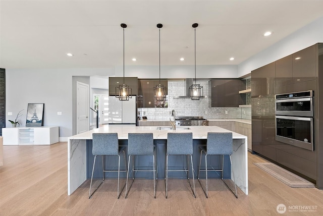 10501 Angeline Rd E, Bonney Lake, WA 98391 - kitchen with modern cabinets, stainless steel double oven, a sink, tasteful backsplash, and light wood-style flooring