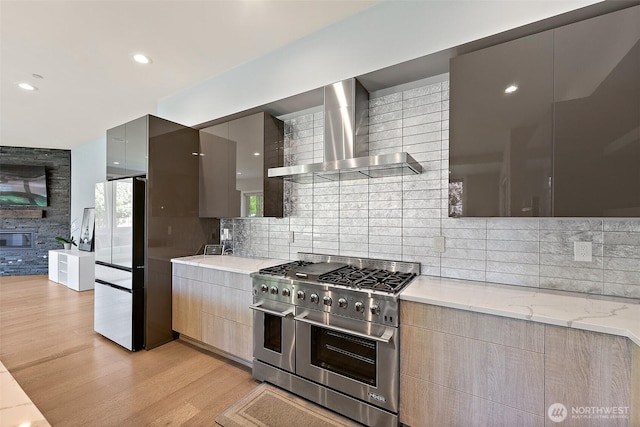 10501 Angeline Rd E, Bonney Lake, WA 98391 - kitchen featuring wall chimney range hood, high end range, freestanding refrigerator, modern cabinets, and recessed lighting