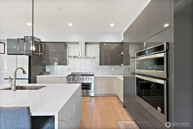 10501 Angeline Rd E, Bonney Lake, WA 98391 - kitchen with modern cabinets, appliances with stainless steel finishes, a sink, wall chimney exhaust hood, and gray cabinets