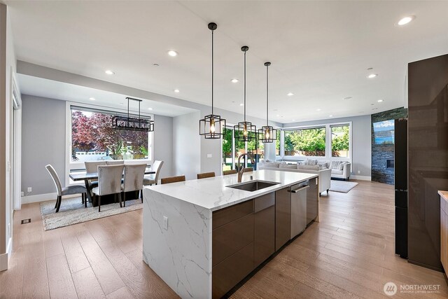 10501 Angeline Rd E, Bonney Lake, WA 98391 - kitchen with a sink, open floor plan, modern cabinets, dishwasher, and light wood-style flooring