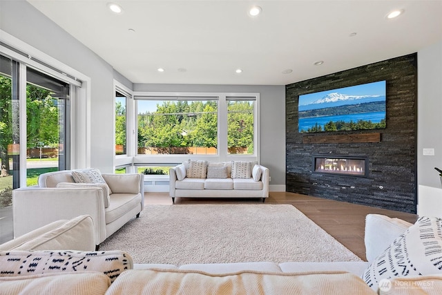 10501 Angeline Rd E, Bonney Lake, WA 98391 - living room featuring wood finished floors, a large fireplace, recessed lighting, and plenty of natural light