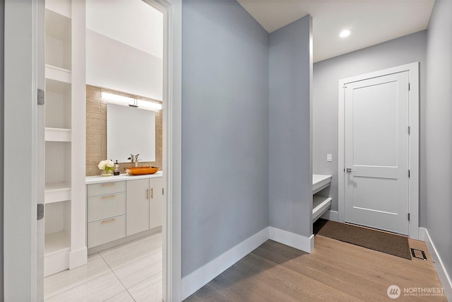 10501 Angeline Rd E, Bonney Lake, WA 98391 - corridor featuring a sink, light wood-type flooring, baseboards, recessed lighting, and built in features