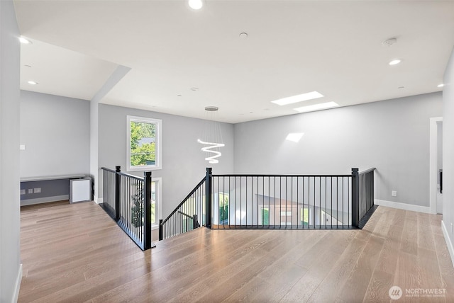 10501 Angeline Rd E, Bonney Lake, WA 98391 - corridor with an upstairs landing, wood finished floors, baseboards, recessed lighting, and a chandelier