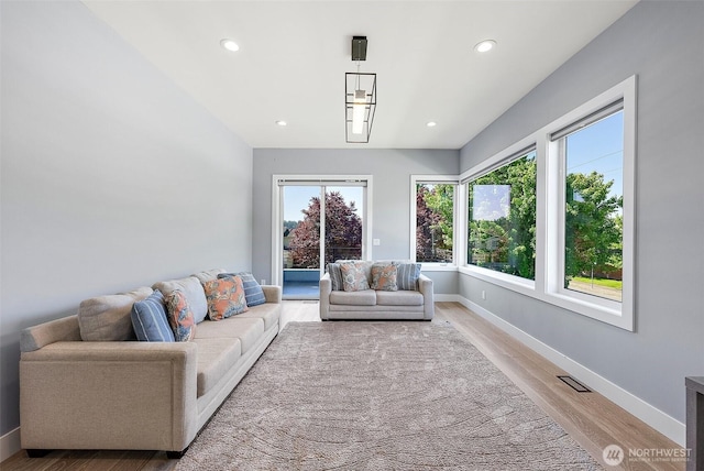 10501 Angeline Rd E, Bonney Lake, WA 98391 - living room featuring baseboards, light wood finished floors, and recessed lighting