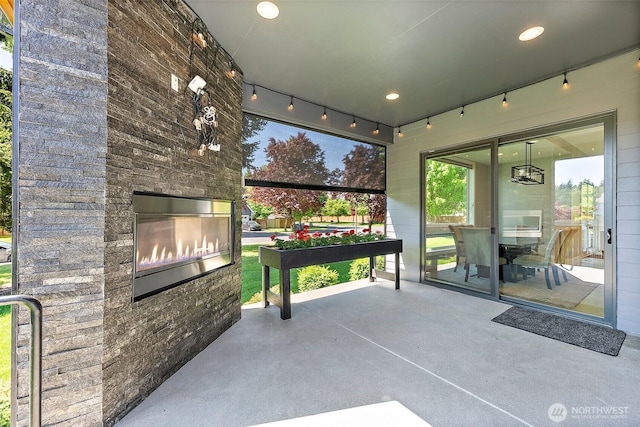 10501 Angeline Rd E, Bonney Lake, WA 98391 - view of patio featuring an outdoor stone fireplace