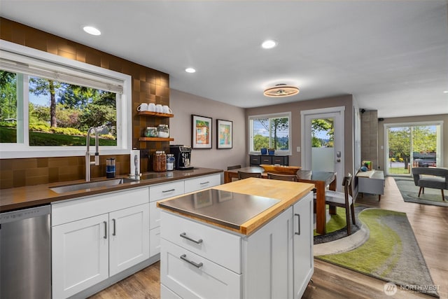7008 155th Pl NE, Redmond, WA 98052 - kitchen with stainless steel dishwasher, wooden counters, tasteful backsplash, light wood-style flooring, and recessed lighting