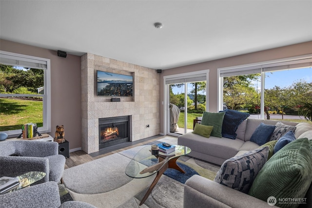 7008 155th Pl NE, Redmond, WA 98052 - living room with plenty of natural light, a tiled fireplace, and wood finished floors