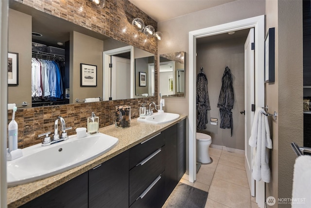 7008 155th Pl NE, Redmond, WA 98052 - full bath with double vanity, tasteful backsplash, tile patterned flooring, and a walk in closet