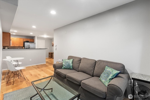 3318 30th Ave SW Unit B402, Seattle, WA 98126 - living area featuring light wood-type flooring, recessed lighting, and baseboards
