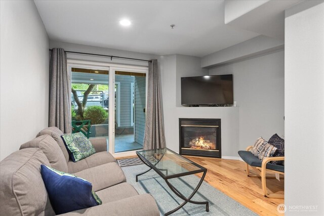 3318 30th Ave SW Unit B402, Seattle, WA 98126 - living room with wood finished floors, a glass covered fireplace, and recessed lighting