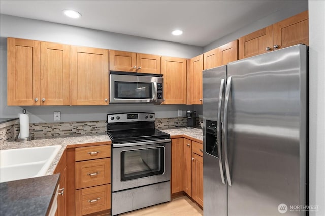 3318 30th Ave SW Unit B402, Seattle, WA 98126 - kitchen with appliances with stainless steel finishes, recessed lighting, light countertops, a sink, and light wood-style flooring