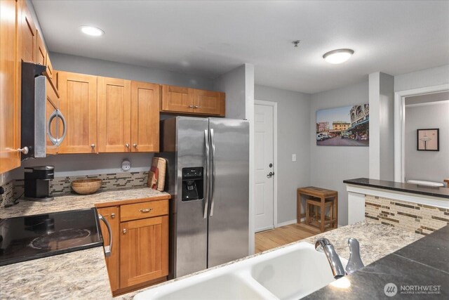 3318 30th Ave SW Unit B402, Seattle, WA 98126 - kitchen featuring stainless steel appliances, light wood finished floors, light countertops, a sink, and recessed lighting