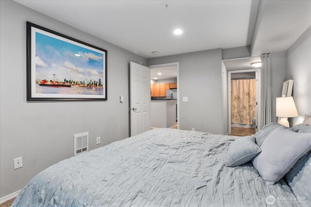 3318 30th Ave SW Unit B402, Seattle, WA 98126 - bedroom featuring recessed lighting, freestanding refrigerator, and baseboards