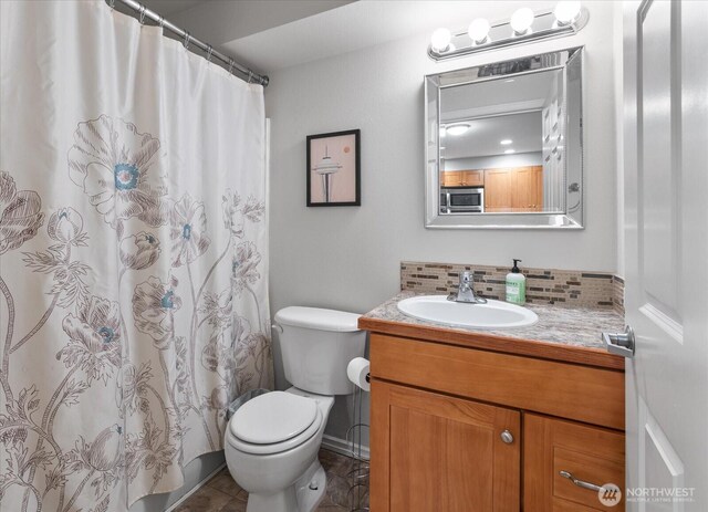 3318 30th Ave SW Unit B402, Seattle, WA 98126 - bathroom with vanity, toilet, backsplash, and a shower with shower curtain