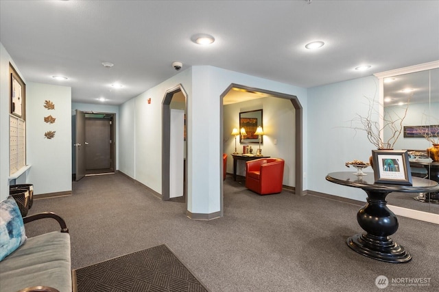 3318 30th Ave SW Unit B402, Seattle, WA 98126 - carpeted living area with arched walkways, baseboards, and recessed lighting