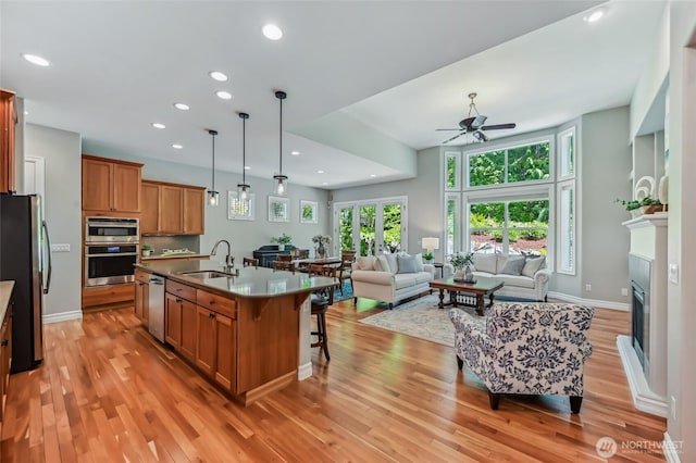 13310 239th Way NE, Redmond, WA 98053 - kitchen featuring a sink, appliances with stainless steel finishes, brown cabinetry, ceiling fan, and recessed lighting