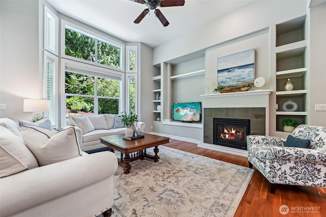 13310 239th Way NE, Redmond, WA 98053 - living room with a ceiling fan, built in features, wood finished floors, and a tile fireplace