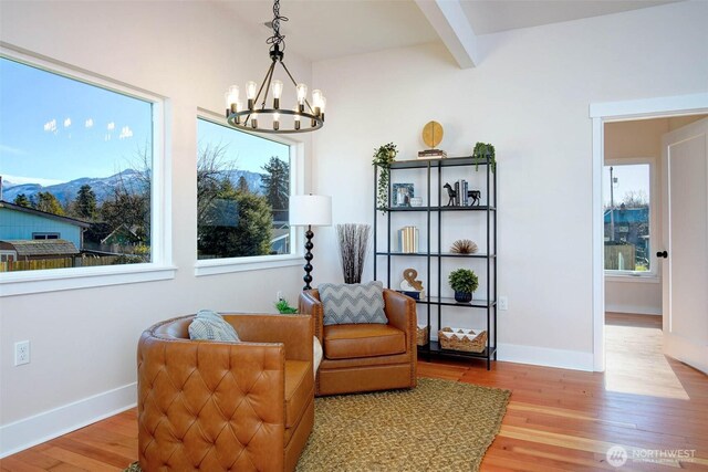 306 3rd St, Sultan, WA 98294 - sitting room featuring a chandelier, wood finished floors, beam ceiling, and plenty of natural light