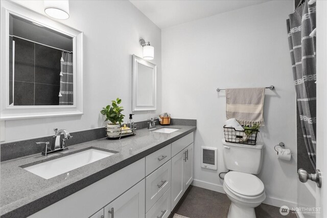 25 140th St SW, Everett, WA 98208 - full bath featuring double vanity, heating unit, toilet, baseboards, and curtained shower
