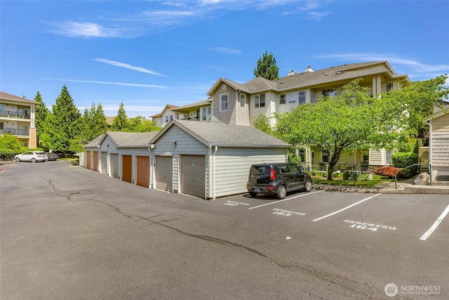 15026 40th Ave W Unit 13-104, Lynnwood, WA 98087 - view of front of property with community garages and roof with shingles
