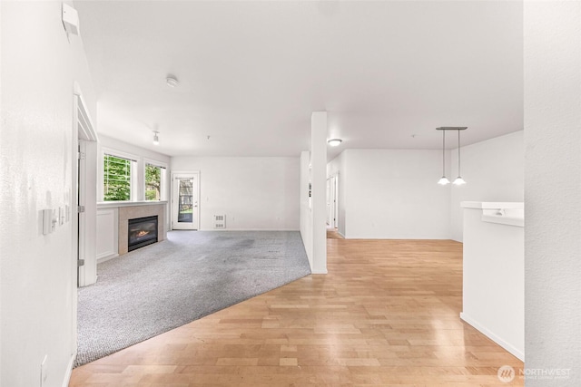 15026 40th Ave W Unit 13-104, Lynnwood, WA 98087 - unfurnished living room with a glass covered fireplace and light wood finished floors