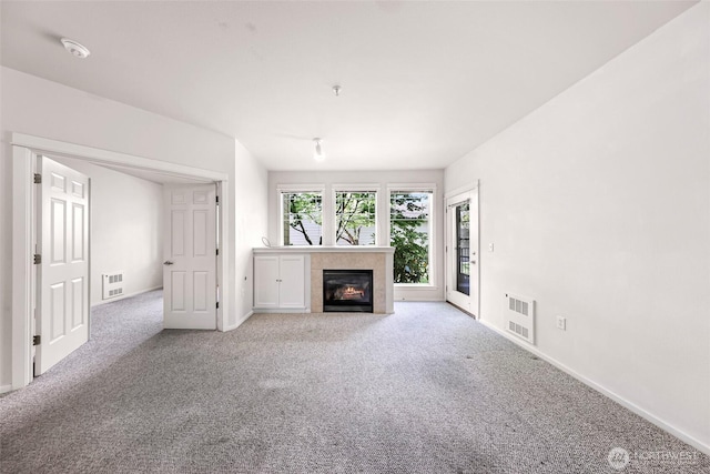 15026 40th Ave W Unit 13-104, Lynnwood, WA 98087 - unfurnished living room with carpet and a fireplace with flush hearth