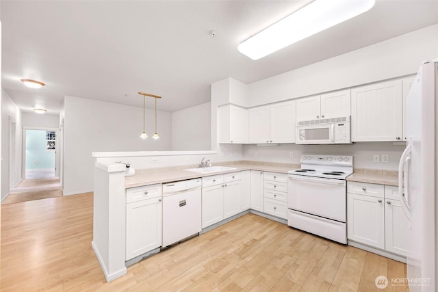 15026 40th Ave W Unit 13-104, Lynnwood, WA 98087 - kitchen featuring white appliances, light wood-style floors, light countertops, and white cabinets