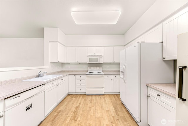 15026 40th Ave W Unit 13-104, Lynnwood, WA 98087 - kitchen featuring white appliances, white cabinetry, light wood-style floors, and light countertops