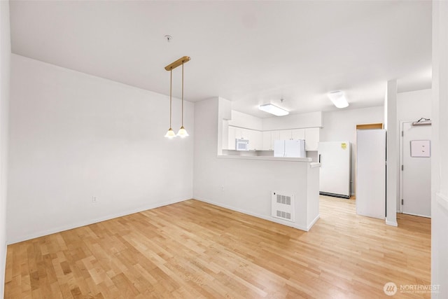 15026 40th Ave W Unit 13-104, Lynnwood, WA 98087 - unfurnished living room with light wood finished floors