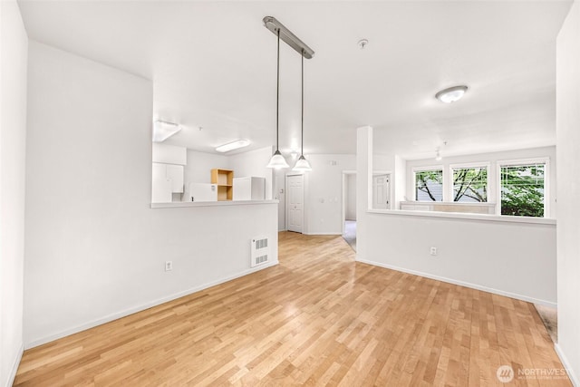 15026 40th Ave W Unit 13-104, Lynnwood, WA 98087 - unfurnished living room featuring wood finished floors and baseboards