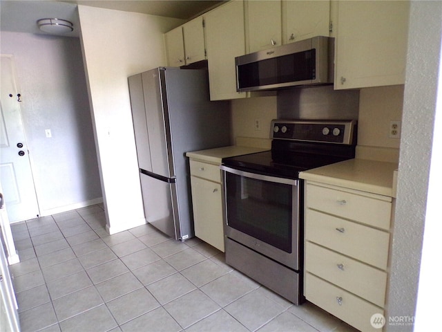 2020 SW 318th Pl Unit C3, Federal Way, WA 98023 - kitchen featuring appliances with stainless steel finishes, light countertops, cream cabinets, and light tile patterned floors