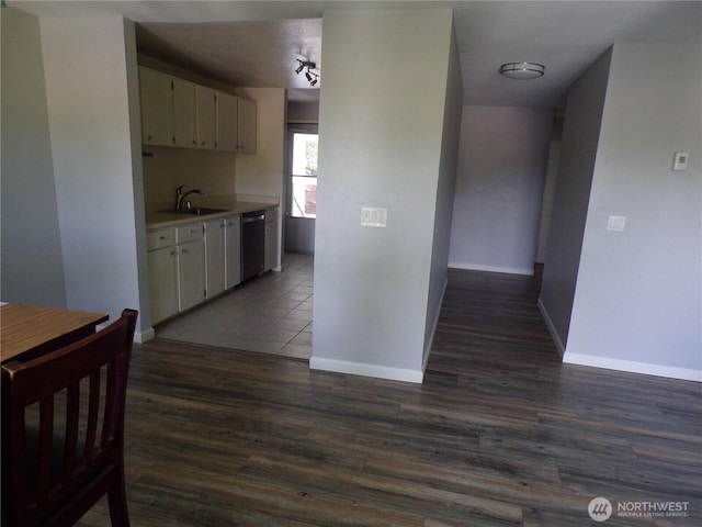 2020 SW 318th Pl Unit C3, Federal Way, WA 98023 - kitchen with dishwasher, a sink, light countertops, baseboards, and dark wood-style flooring