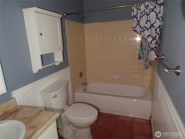 2020 SW 318th Pl Unit C3, Federal Way, WA 98023 - bathroom featuring vanity, shower / tub combo with curtain, a wainscoted wall, toilet, and tile patterned floors