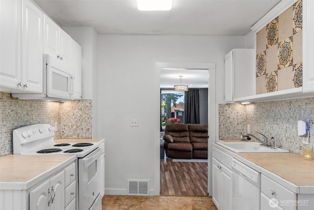 212 N Michigan St, Aberdeen, WA 98520 - kitchen with white appliances, a sink, white cabinets, and light countertops