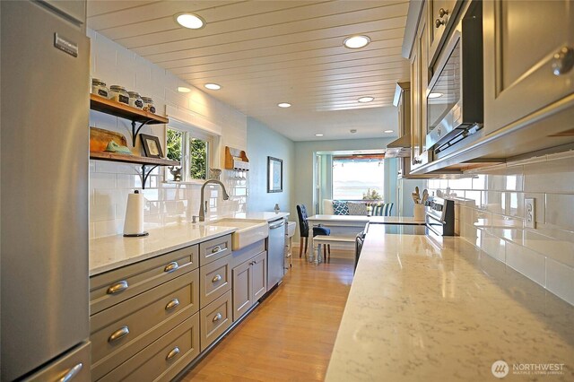 987 Cavalero Rd, Camano Island, WA 98282 - kitchen featuring appliances with stainless steel finishes, a sink, open shelves, recessed lighting, and decorative backsplash