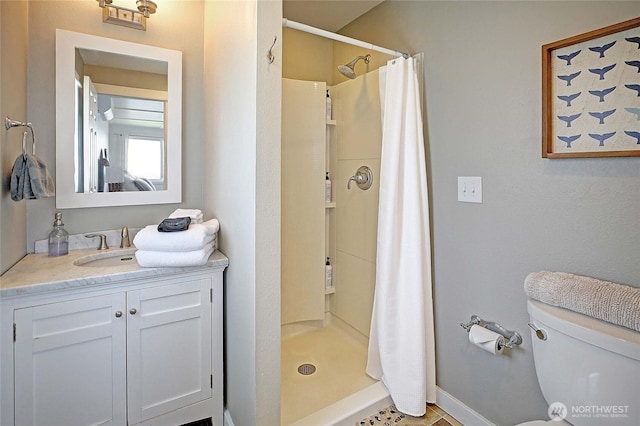 987 Cavalero Rd, Camano Island, WA 98282 - full bathroom featuring vanity, a stall shower, toilet, and baseboards