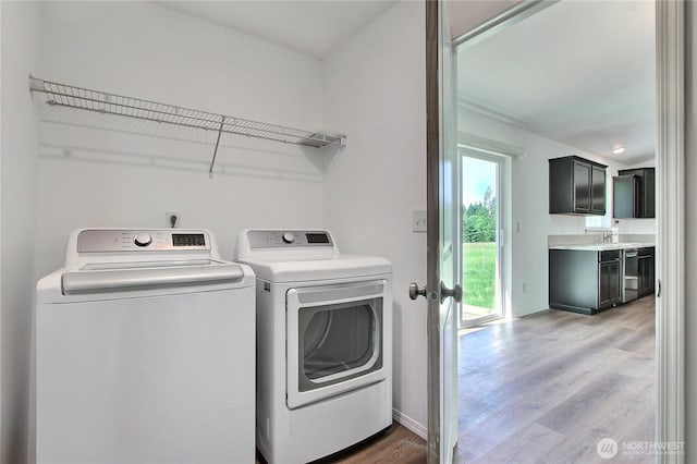 250 Hewitt Rd Unit 23, Chehalis, WA 98532 - laundry area with washer and clothes dryer, light wood finished floors, and baseboards