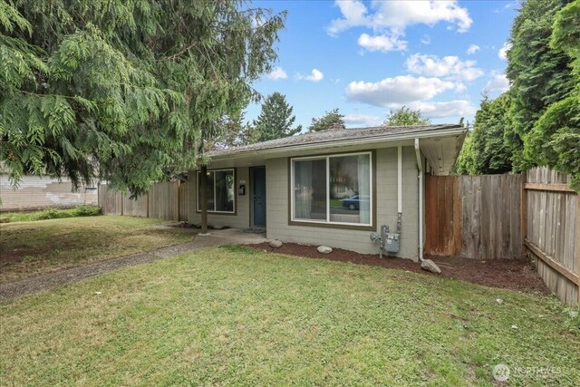 1412 Mcmillan Ave, Sumner, WA 98390 - view of front of home featuring concrete block siding and a shingled roof