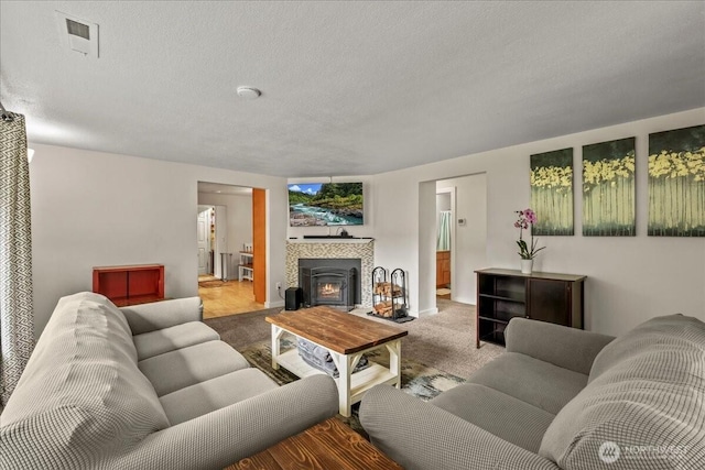 1412 Mcmillan Ave, Sumner, WA 98390 - carpeted living area with a fireplace, a textured ceiling, and baseboards
