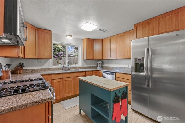 1412 Mcmillan Ave, Sumner, WA 98390 - kitchen featuring stainless steel appliances, a sink, wooden counters, and open shelves