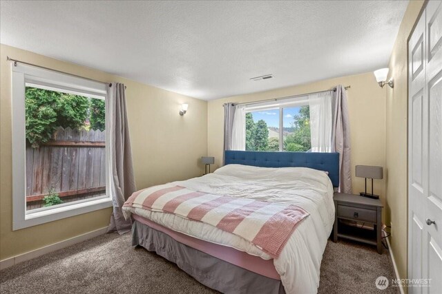 1412 Mcmillan Ave, Sumner, WA 98390 - carpeted bedroom featuring a textured ceiling and baseboards