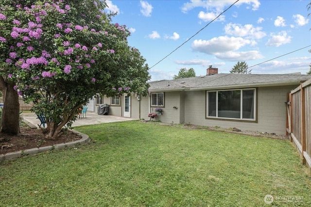 1412 Mcmillan Ave, Sumner, WA 98390 - back of house with a patio, concrete block siding, and a chimney