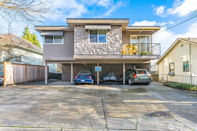 4456 Whitman Ave N, Seattle, WA 98103 - view of front of home featuring stone siding, stucco siding, and a balcony