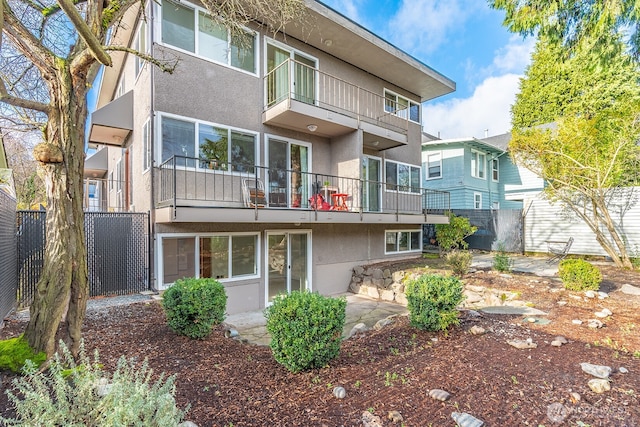 4456 Whitman Ave N, Seattle, WA 98103 - back of house with a balcony, stucco siding, and a patio
